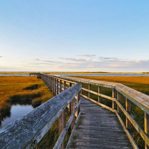 Catching the first light of sunset off Great South Bay at Cedar Beach Marina Pier.