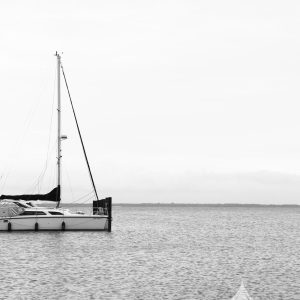 Sailboat parked at the edge of docks in Ocean Bay Park, Fire Island