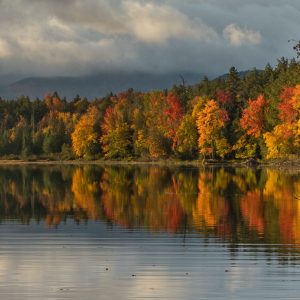 Fall colors reflected in the calm early morning waters of the Saranac Boat Launch.