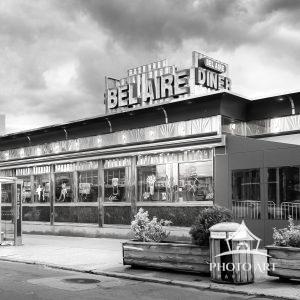 An old diner along the street of Long Island City, Queens, NY, and people at the bus stop. Street