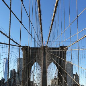 A spider web effect on the Brooklyn Bridge, Brooklyn. The Freedom Tower in the background.