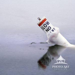 Buoy frozen in the cold inlet in the middle of winter near the Great South Bay along the south shore