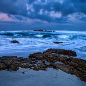 A clearing storm off the coast of the Monterey Peninsula, as a touch of pink in the sky serves as