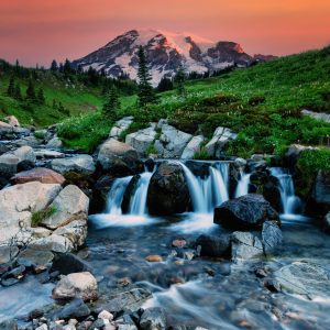 Colorful dawn at Myrtle Falls, with Mt. Rainier looming over the landscape in the distance. Mt.