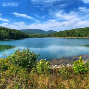 A panoramic view of a peaceful lake with no one else around. This is in Acadia National Park in Bar