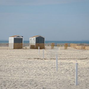 In the distance at Jones Beach's expansive sand, stands a pair of huts that give the landscape