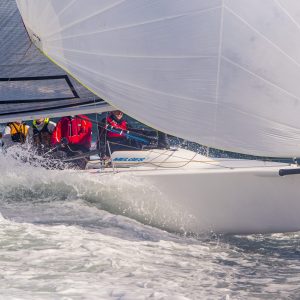 Melges 24, "Wasn't Me" blasts thru waves while planing at top speed to overall honors in the