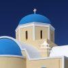 Church Domes – Santorini 17 Blue, white and yellow church domes against the crisp blue sky in Santorini, Greece.