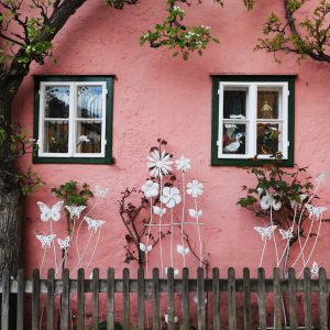 Pink house with butterfly garden in Hallstatt, Austria.