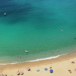 Aerial view of  beach-goers enjoying some R&R on Tropea beach, Calabria.