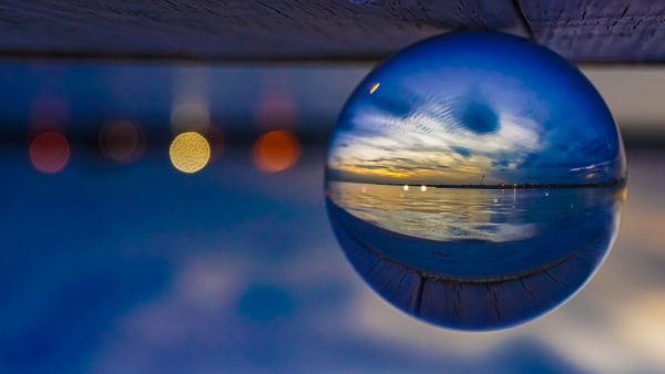 Lights glimmer in a reflected view of Mascot Dock in Patchogue at sunset.