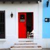 Watch dog by red door 19 Dog peeping out a colorful red door in Old San Juan, Puerto Rico.