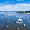 An aerial view of Northport Harbor with many boats still anchored up for the day. Many people keep