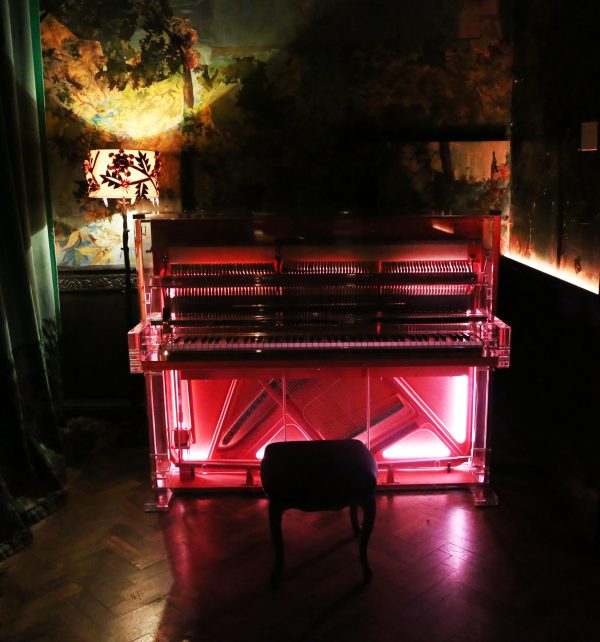 Neon pink-lit piano. London, England,