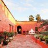 Vivid Garden Terrace – Oaxaca 13 Vivid Orange garden terrace filled with pretty flowers, before sunset. Oaxaca, Mexico.