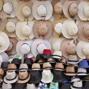 All types of cool hats - sombreros and fedoras on display.  Cartagena, Colombia. Color photo.