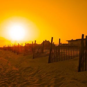 Bright yellow sunsent over the homes and beaches of Seaview, Fire Island.
