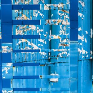 This image brings to life a rusted and paint-worn warehouse wall that combines an urban vibe with