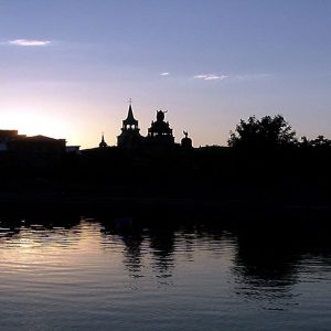the church of notre dame de bon secours in old montreal as sun sets over the lake..