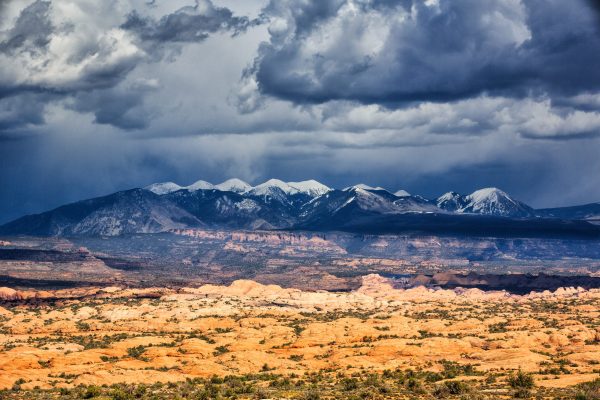 A rainstorm provides some drama over the La Sal Mountains on the border of Arches National Park,