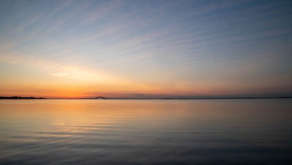 A view of the Robert Moses Bridge from the Babylon Docks at sunrise. The colors are beautiful and
