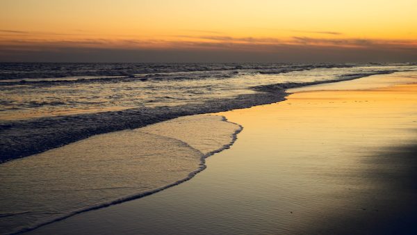I absolutely love the orange reflections in the sand created by this sunset. There was a heavy cloud