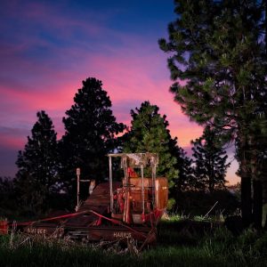 Old farming equipment with sunset