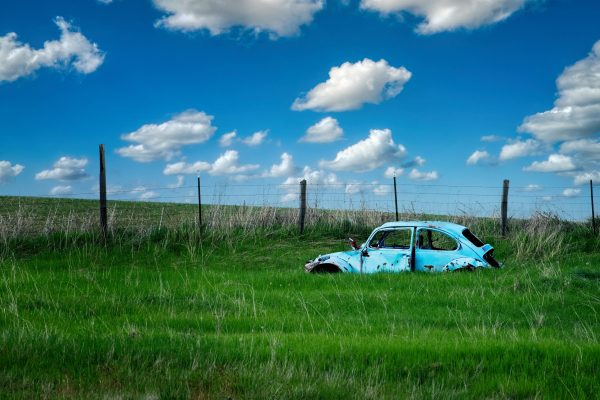 Old Volkswagen Beetle in a field.