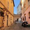This fine art photograph captures the essence of a quiet and charming residential street in the