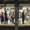 Subway riders waiting for a train in this painterly image.