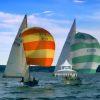 Lightening Class sailboats racing neck and neck with their colorful spinnakers in bloom.