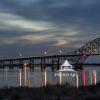 Last of the twilight peeks thru the clouds and the bridge lights reflecting on the water below make