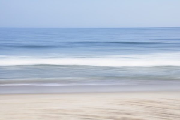A sweeping blur of the beach, ocean, and sky captures the feeling.