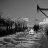 This is a black and white photograph of a ski lift scene at Stratton, Vermont. Two skiers are seated