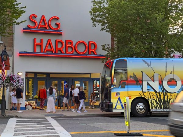 The Hampton Jitney wrapped in colorful ads, makes an interesting composition as it pulls up in