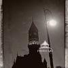 The sepia photograph presents a dramatic night time scene featuring The Jefferson Market Branch of