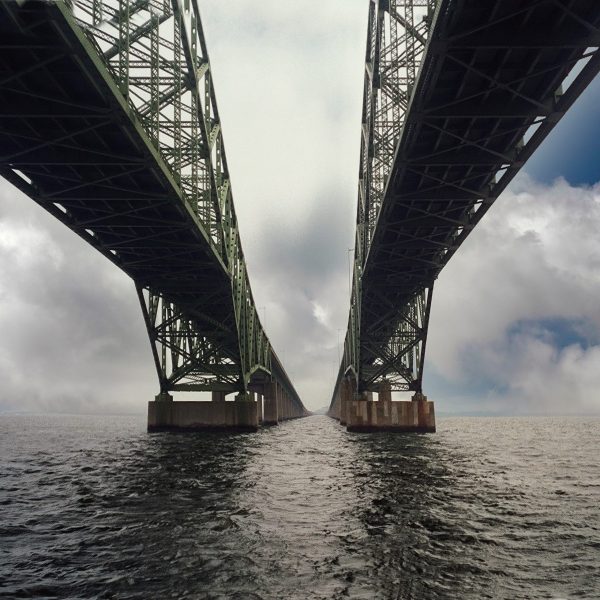 The photograph showcases the understructure of the Robert Moses Bridge extending over the Fire