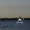 Soft light from the setting sun illuminating the skyline and the harbor. Late boaters enjoying the