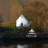 A small chapel nestled between the banks of the Rhine River, and a local road. Set on the slopes