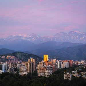 As the day transitions to night, the city of Santiago de Chile is bathed in the glow of a