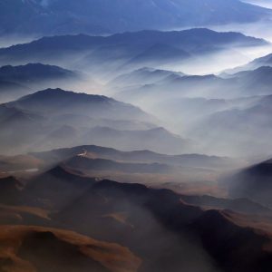 An aerial view capturing the breathtaking transition from the towering peaks of the Andes Mountains