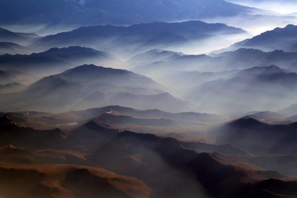 An aerial view capturing the breathtaking transition from the towering peaks of the Andes Mountains