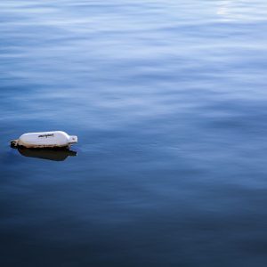 Lone white buoy floating in the winter waters of Long Island Sound. Massapequa, Long Island. NY