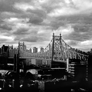 This is photograph of the Queensboro bridge spanning the East River in Manhattan. Under the