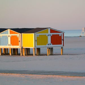 The vibrant early morning sun beaming off of the beach huts on the beach of Wildwood Crest, NJ