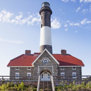 This is the southern view of the front  of the Fire Island Lighthouse. Note its bright red roof.