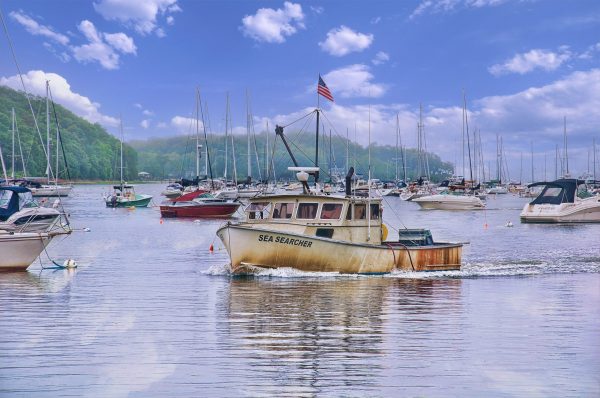 Northport harbor creates a peaceful maritime scene with numerous boats anchored. The primary focus