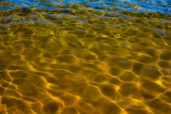 Liking the abstract look of Tahoes surf and sand with all the reflections..