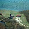 This is an aerial view of a coastal landscape. The photo showcases the Block Island lighthouse