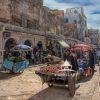 This image is a vibrant, detailed photograph capturing a bustling street market in Morocco. The